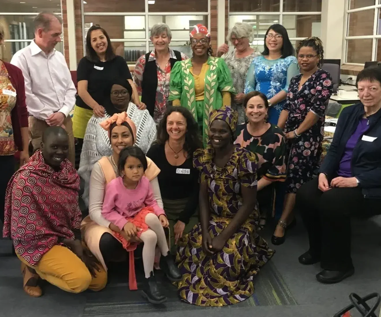 Diverse group gathered indoors for community event.
