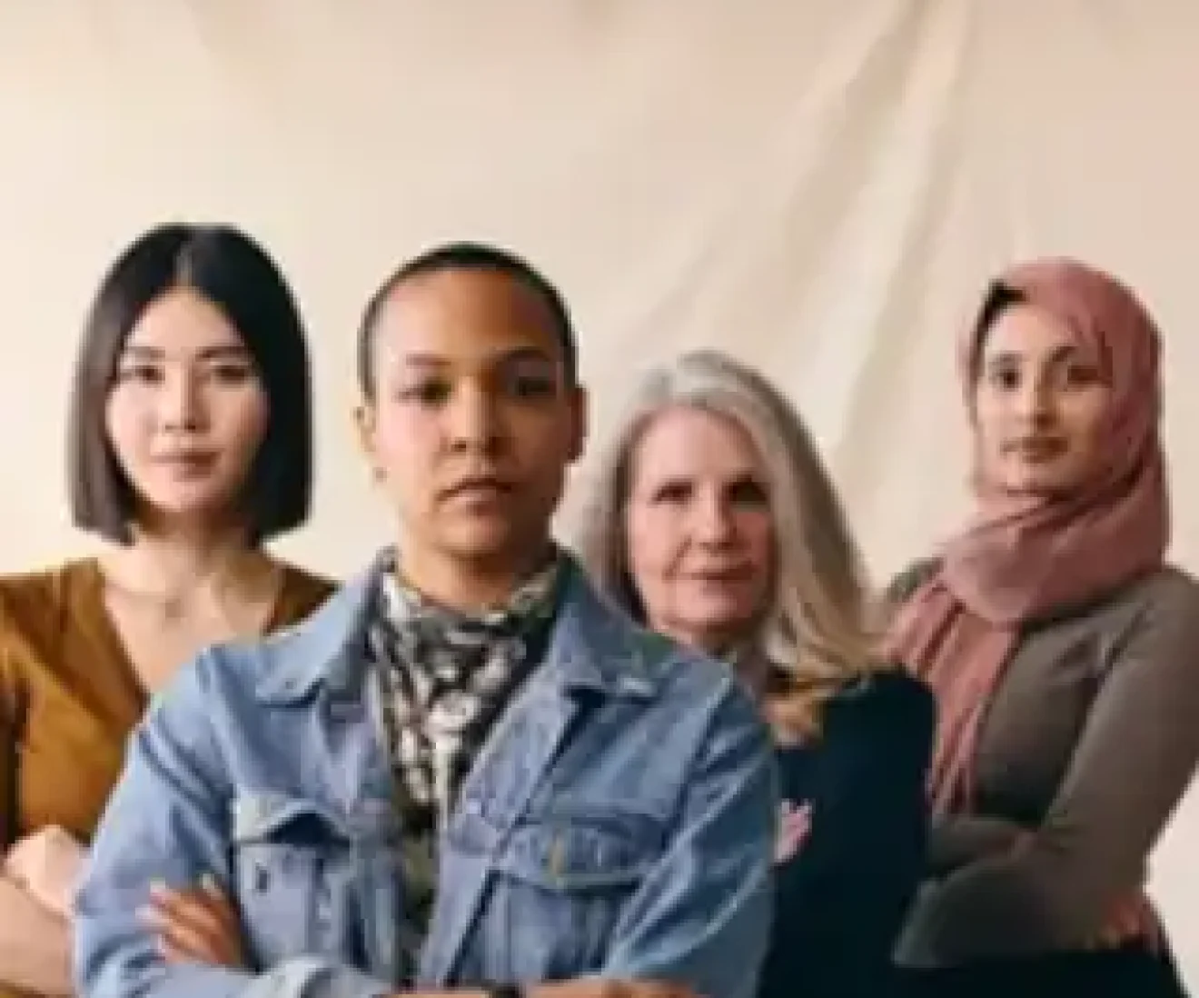 Diverse group of four confident women standing together.
